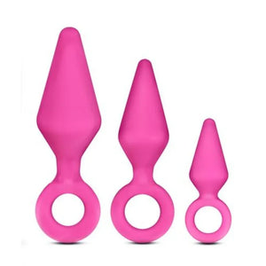 Set of three pink silicone anal plugs with tapered tips and ring handles in small, medium, and large sizes