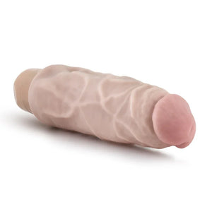 Realistic flesh-tone cock-shaped vibrator with veined texture and rounded pink tip on white background