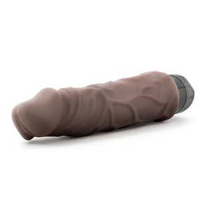 brown realistic textured vibrator with black base lying on white background