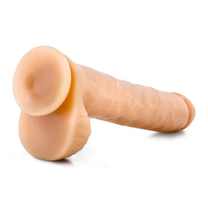 Realistic flesh-toned dildo with suction base on white background