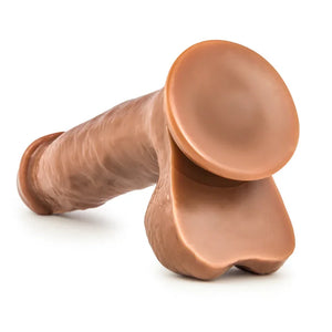 Realistic brown silicone dildo with suction base on white background