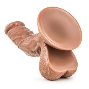 Realistic brown silicone dildo with suction cup base on a white background