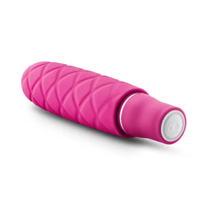 Luxe Cozi Mini vibrator in vibrant fuchsia with textured silicone surface on white background