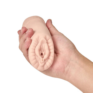 Hand holding a realistic flesh-toned male masturbator sleeve shaped like female genitalia