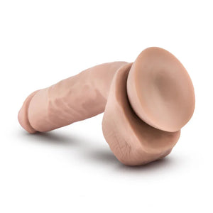 Realistic flesh-toned silicone dildo with suction base on a white background