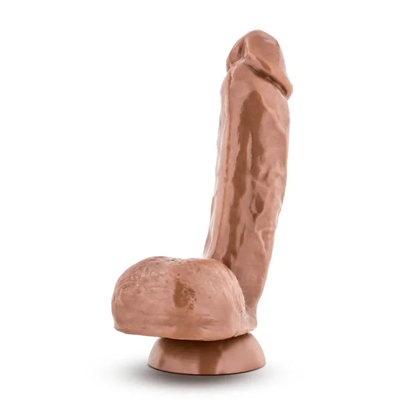 Realistic brown dildo with suction base on white background, adult novelty toy