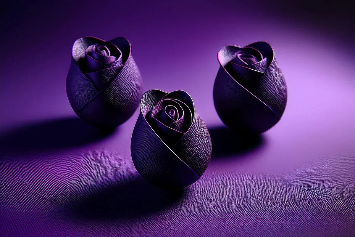 Three black leather roses on textured purple surface with dramatic lighting and shadows