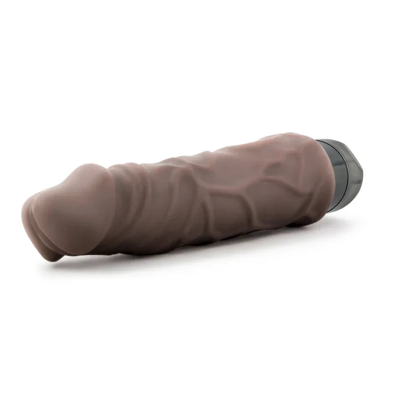 brown realistic textured vibrator with black base lying on white background