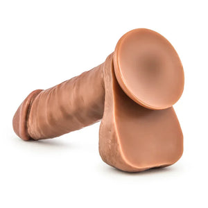 Realistic brown dildo with attached suction cup base on white background