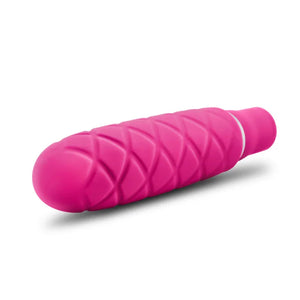 Compact fuchsia Luxe Cozi Mini vibrator with quilted texture on white background