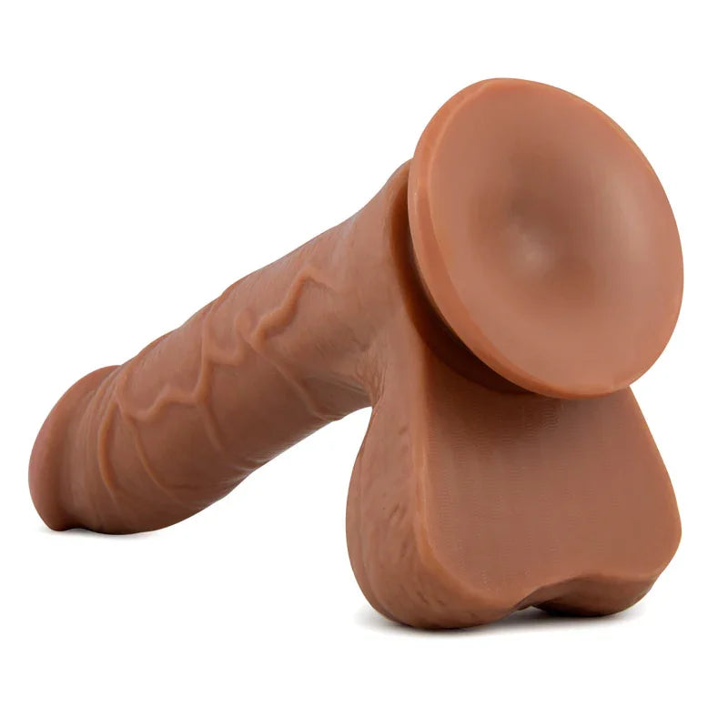 Realistic brown dildo with detailed veins and suction base on white background