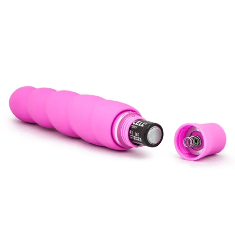 Pink segmented vibrator with removable cap showing inserted AA battery on white background